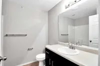 Bright and modern bathroom featuring sleek fixtures, a large mirror, and elegant countertop for a luxurious feel.