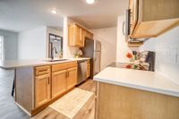 Bright and modern kitchen with elegant wooden cabinetry, sleek countertops, and stainless steel appliances for a cozy home atmosphere.