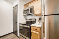 Modern kitchen featuring stainless steel appliances, sleek cabinetry, and a stylish subway tile backsplash.