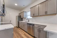 Sleek modern kitchen with stainless steel appliances, elegant marble countertops, and stylish cabinetry, perfect for culinary creativity.