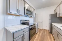 Modern kitchen with sleek cabinets, stainless steel appliances, and elegant marble countertops.