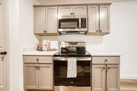 Modern kitchen with sleek cabinets, stainless steel appliances, and a polished marble countertop, ideal for culinary enthusiasts.