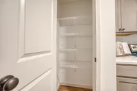Inviting pantry space with sleek wire shelving, perfect for organized kitchen storage.
