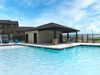 Inviting outdoor pool area with modern lounge seating and a relaxing cabana, perfect for enjoying sunny days.