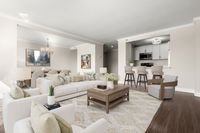 Elegant open-concept living space featuring stylish living and dining areas, and a modern open kitchen with bar seating at Parkside Place, apartments in Cambridge, MA