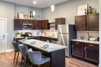 Modern kitchen with sleek stainless steel appliances and elegant granite countertops.