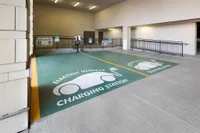 Modern apartment parking facility featuring eco-friendly electric vehicle charging stations, offering convenience and sustainability.