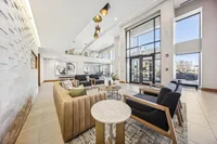 Bright and inviting lobby featuring modern seating, stylish lighting, and expansive windows with a contemporary design.