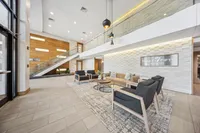 Modern and inviting lobby area of Ninety7Fifty on the Park, featuring stylish seating, elegant lighting, and a contemporary staircase.