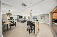 Chic and inviting communal lounge area featuring elegant seating, stylish lighting fixtures, and a cozy fireplace, perfect for relaxation and socializing.