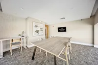 Modern conference room with a sleek wooden table, comfortable chairs, and stylish decor at Ninety7 Fifty on the Park.