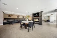 Inviting lounge space featuring cozy seating, a modern fireplace, and elegant lighting, perfect for relaxation and gatherings.