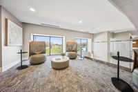 Modern lounge area with plush seating, sleek tables, and large windows offering scenic outdoor views.