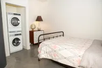 Cozy Bedroom Featuring Laundry Area