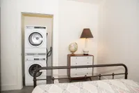Cozy Bedroom Featuring Laundry Area