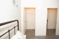 Cozy Bedroom Featuring Walk-In Closet