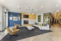 Inviting modern lobby with stylish seating, elegant lighting, and a cozy fireplace, creating a warm and welcoming atmosphere.
