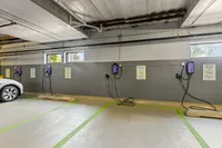 Modern parking garage with dedicated electric vehicle charging stations, offering convenience and eco-friendly amenities.