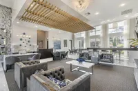 Elegant and contemporary lobby featuring luxurious seating, modern decor accents, and expansive windows for natural light.