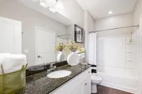 Elegant bathroom with sleek granite countertop, modern fixtures, and tasteful decor, offering a serene and luxurious retreat.