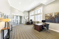 Elegant leasing office with modern decor, featuring large windows, stylish desks, and contemporary artwork.