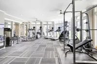 Bright and modern fitness center equipped with state-of-the-art gym equipment and large windows for natural light.