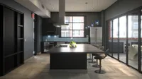 Sleek and modern kitchen with a spacious island, designer pendant lighting, and stylish backsplash. Features large windows flooding the space with natural light.
