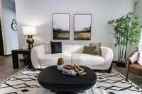 Cozy and modern living room with a stylish white sofa, chic art pieces, and elegant decor.