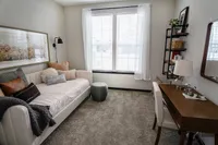 Inviting cozy room with elegant daybed, chic decor, and a bright window creating a serene atmosphere.