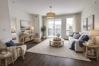 Elegant and airy living room featuring modern decor with cozy seating, natural light through large windows, and a chic round coffee table.