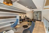 Contemporary office space with chic decor, featuring modern workstations and elegant seating in a stylish open layout.