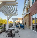Charming outdoor patio with modern seating, elegant pergolas, and vibrant greenery offering a perfect relaxation spot.
