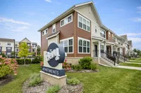 Charming townhouse-style apartments at The Bevy with lush landscaping and inviting exterior, ideal for modern living.