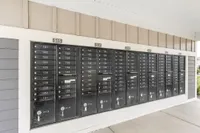 Contemporary apartment mailroom with sleek, organized mailbox units under a sheltered area.
