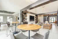 Modern open-concept living space with elegant seating, stylish dining area, and large windows for natural light.
