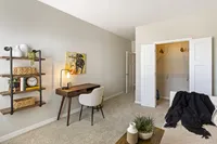 Charming home office space with modern wooden desk, cozy chair, and decorative shelving, perfect for inspiring productivity.