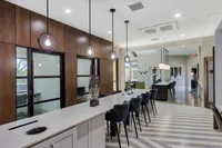 Chic modern communal space with elegant lighting, stylish seating, and a sophisticated design.