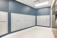 Modern apartment mailroom featuring sleek white mailboxes and stylish blue accent wall, offers convenience and security.