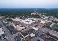 Vibrant aerial view showcasing a modern urban neighborhood with stylish apartment complexes surrounded by lush greenery.