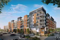 Modern apartment complex showcasing sleek architecture with spacious balconies and lush landscaping, set under a clear blue sky.