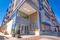 Modern apartment complex exterior with sleek design and large windows at The VUE.