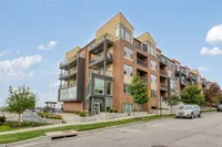 Modern apartment building with stylish balconies and large windows at Apex on Quality Hill, set against a clear blue sky.