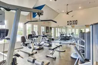 Bright and modern fitness center equipped with state-of-the-art exercise machines and free weights, offering a refreshing workout environment.