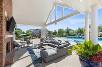 Luxurious outdoor lounge area with modern seating and pool view, ideal for relaxation and entertaining.