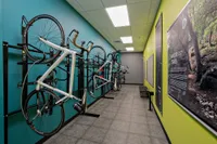 Modern bike storage room featuring multiple bicycles on wall-mounted racks, vibrant colored walls, and a sleek design perfect for urban living.