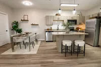 Open kitchen and dining area in a newly renovated apartment at Enclave at 127th in Plainfield.