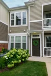 Private apartment entrance with landscaped greenery at Enclave at 127th in Plainfield, IL