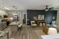 Newly renovated open-concept apartment home with spacious living room and kitchen.