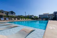 Inviting outdoor pool area with sun loungers and umbrellas, perfect for relaxation and leisure on a sunny day.