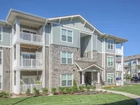 3 story building exterior with balconies.